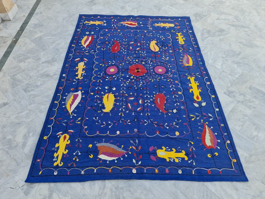 Custom hand-embroidered flatweave rug in blue embroidered hooked, woven to order by Rug Gossips in Lahore