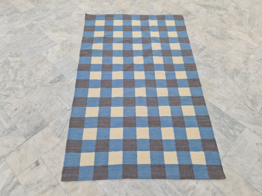 Custom flatweave kilim rug in blue grey white checkered, woven to order by Rug Gossips in Lahore