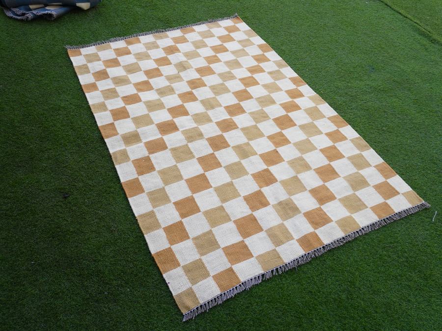 Custom flatweave kilim rug in brown and white checkered, woven to order by Rug Gossips in Lahore