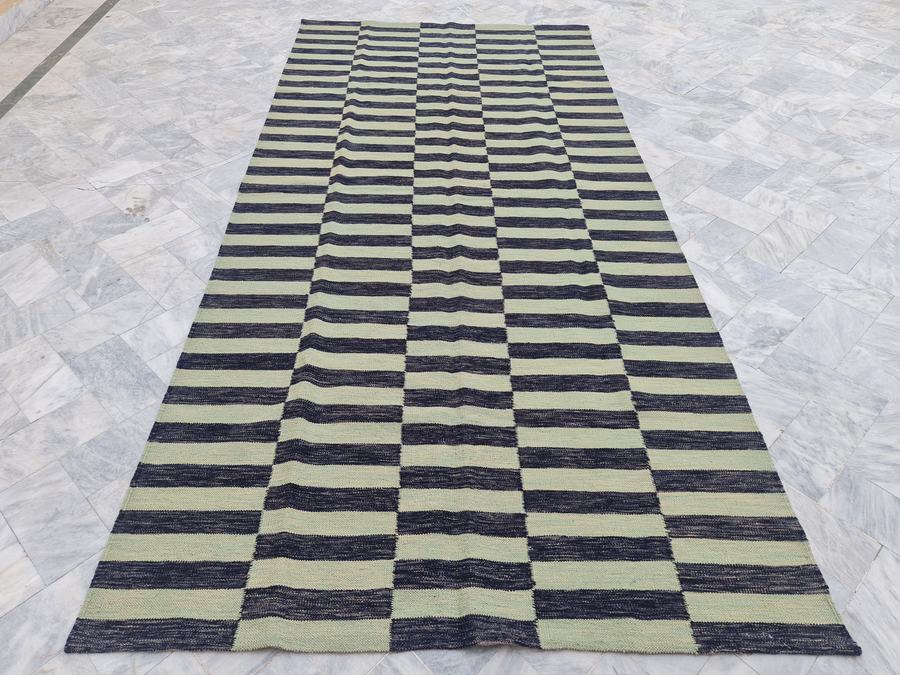 Custom flatweave kilim rug in green and black striped kilim, woven to order by Rug Gossips in Lahore