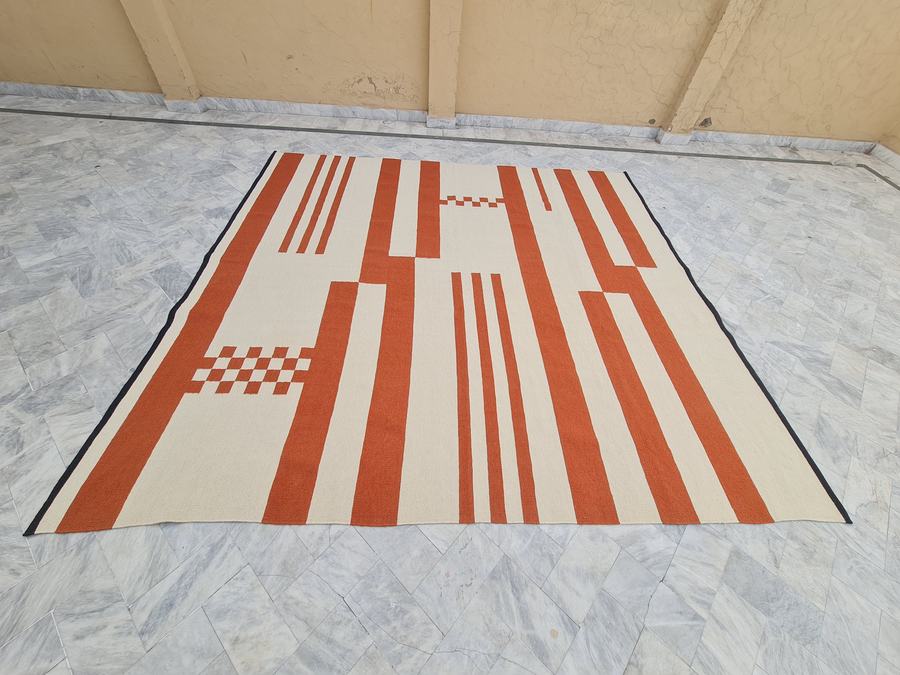 Custom flatweave kilim rug in orange and white, woven to order by Rug Gossips in Lahore