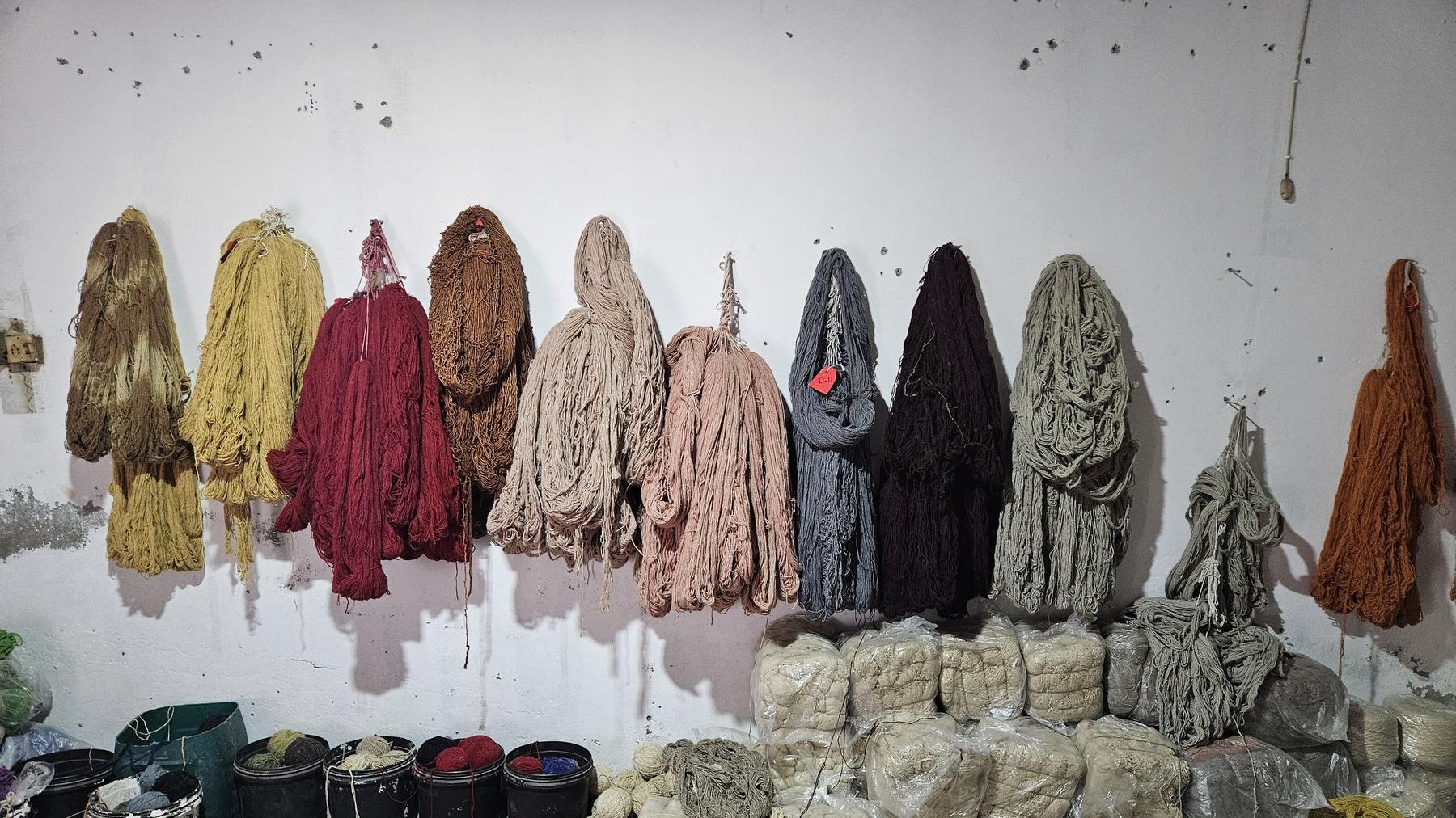 A wall of hand-dyed wool skeins in the Rug Gossips dye house, Lahore