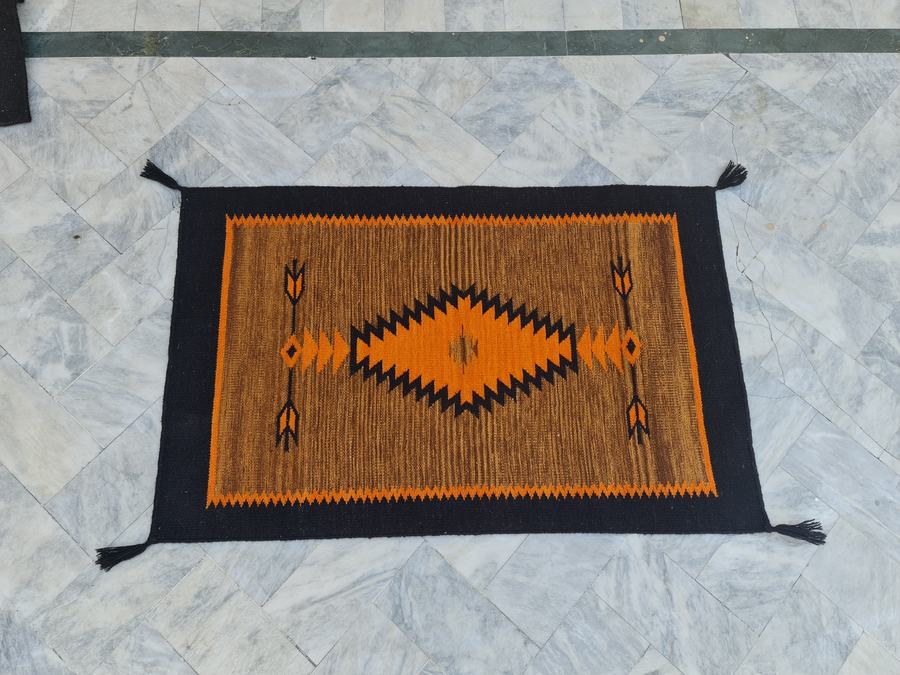 Custom Southwestern Navajo-style flatweave rug in orange black navajo, woven to order by Rug Gossips in Lahore